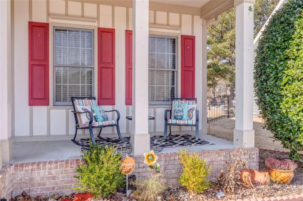 9620 Coastal Pointe Drive Villa Rica, GA 30180 - Photo 4 of 65 a view of balcony with two chairs potted plants and wooden walls
