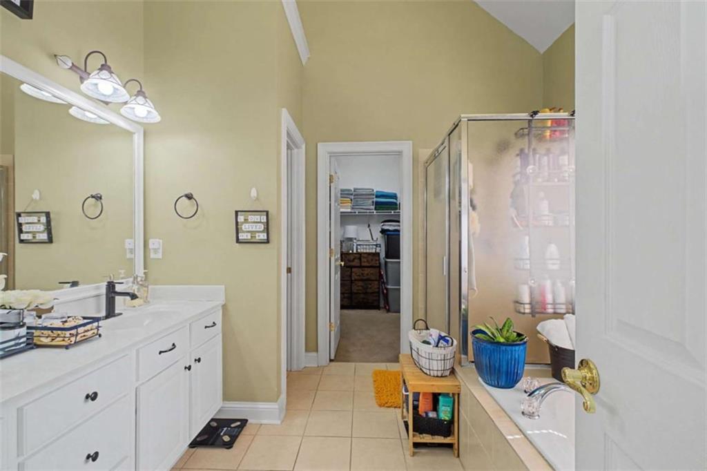 9620 Coastal Pointe Drive Villa Rica, GA 30180 - Photo 49 of 65 a spacious bathroom with a granite countertop sink a toilet a mirror and shower