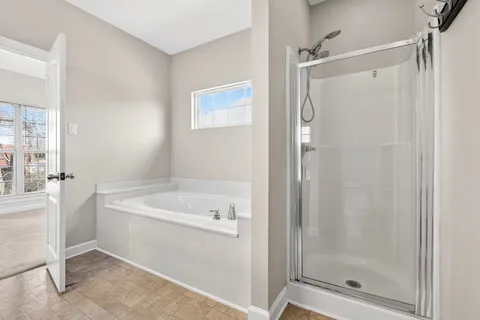 a bathroom with a bathtub and a shower