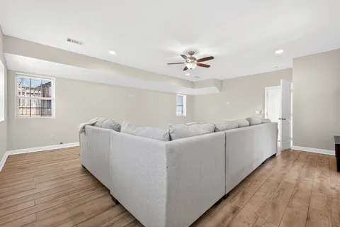 a living room with furniture and a wooden floor