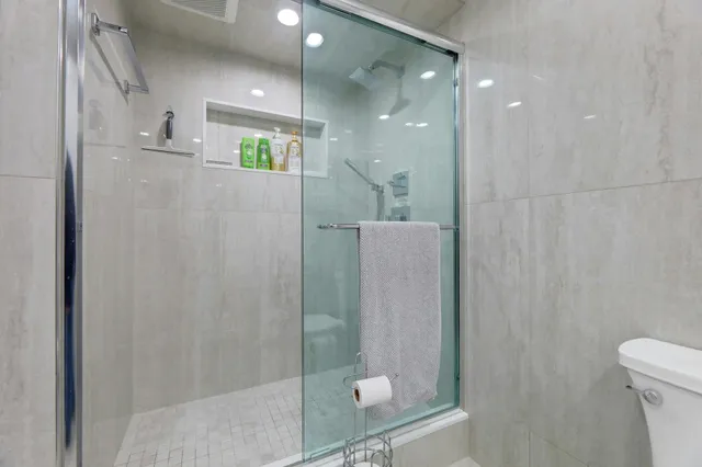 a bathroom with a shower and a toilet