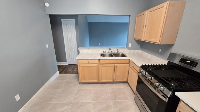 a kitchen with a refrigerator sink and cabinets