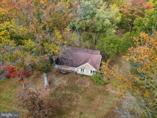 an aerial view of residential building and trees around