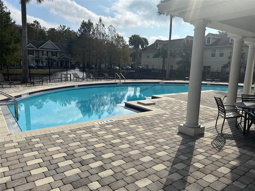 10106 Regent Square Drive, Unit 209 Orlando, FL 32825 - Photo 12 of 19 a view of a swimming pool with a patio