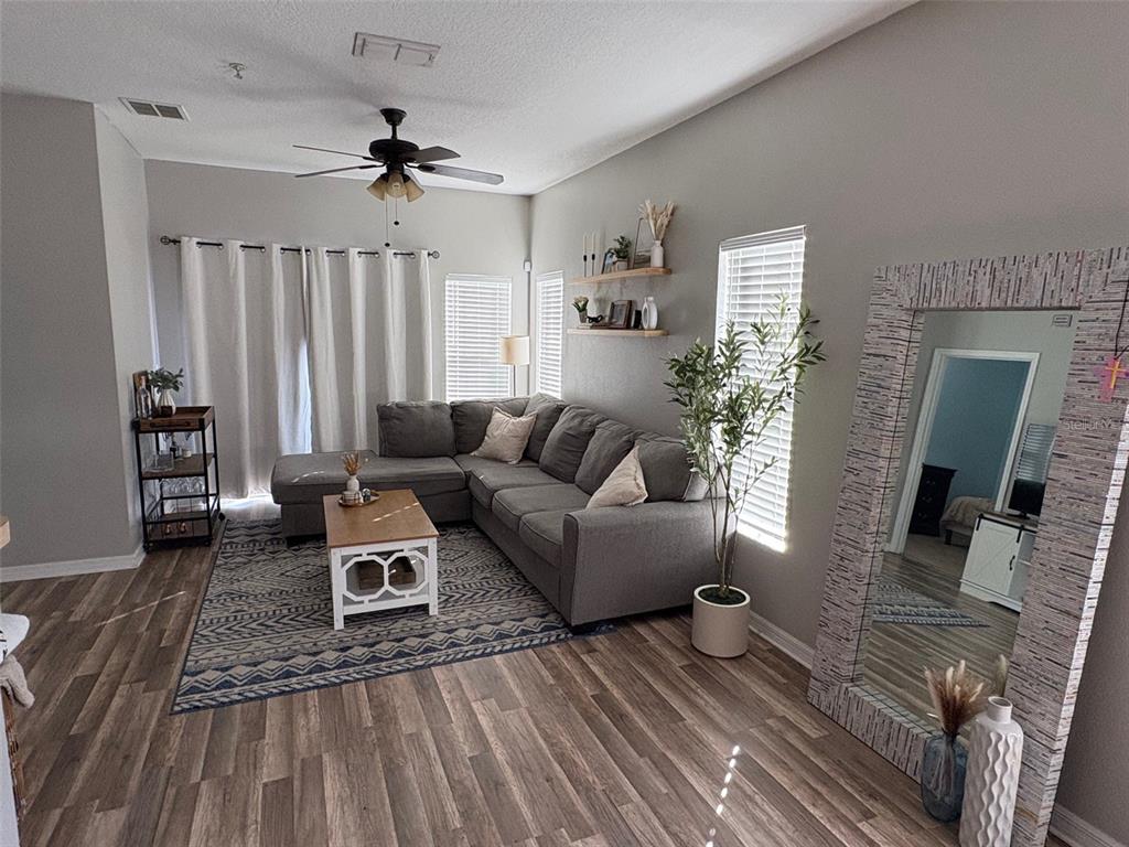 10106 Regent Square Drive, Unit 209 Orlando, FL 32825 - Photo 3 of 19 a living room with furniture and a large window