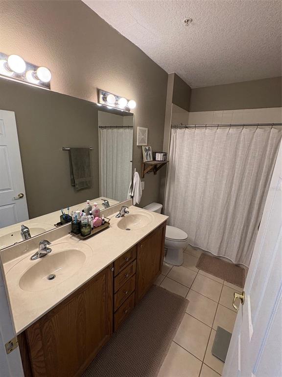10106 Regent Square Drive, Unit 209 Orlando, FL 32825 - Photo 8 of 19 a bathroom with a sink a toilet and a mirror