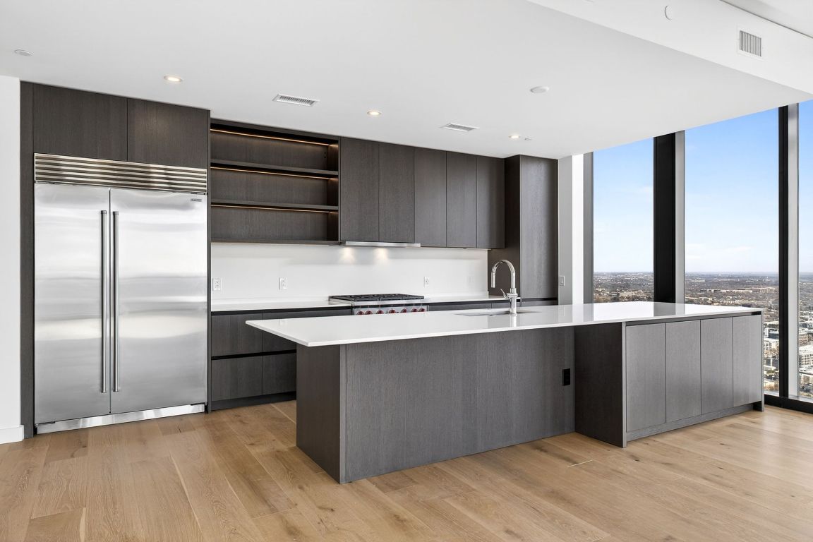 610 Davis Street, Unit 5001 Austin, TX 78701 - Photo 11 of 38 a kitchen with stainless steel appliances a refrigerator and a sink