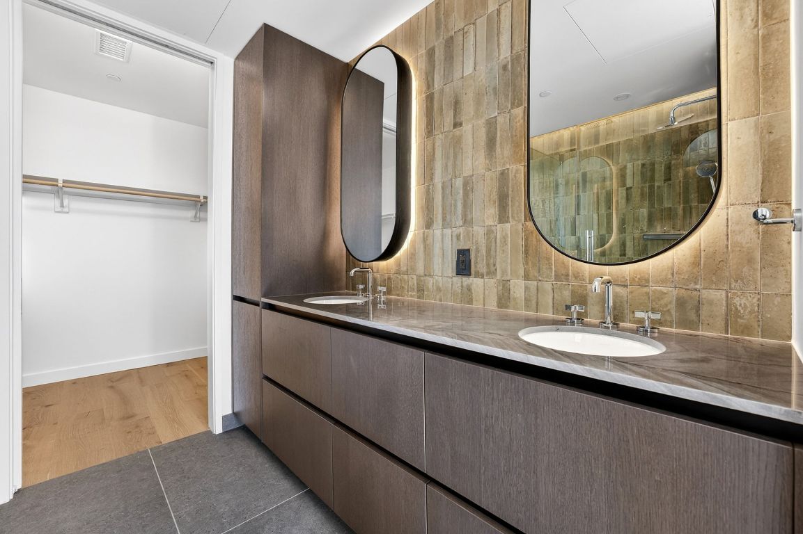610 Davis Street, Unit 5001 Austin, TX 78701 - Photo 21 of 38 a bathroom with a double vanity sink and a mirror