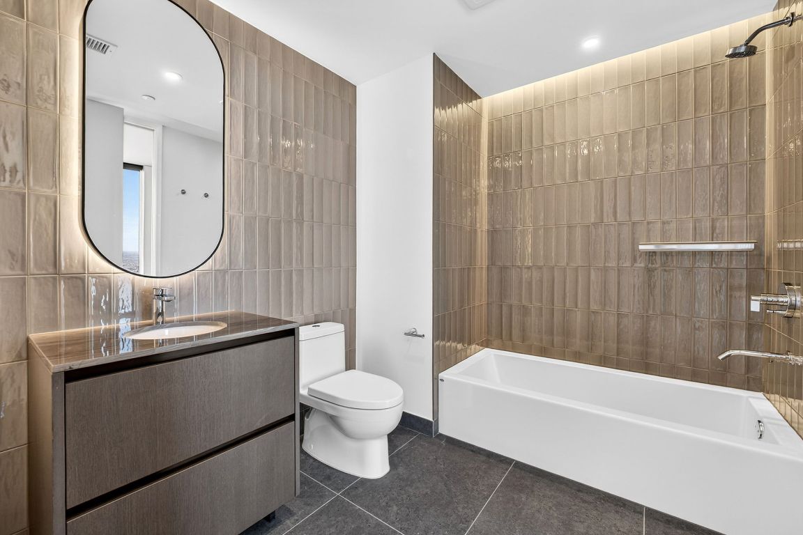610 Davis Street, Unit 5001 Austin, TX 78701 - Photo 24 of 38 a bathroom with a sink toilet a shower and bathtub