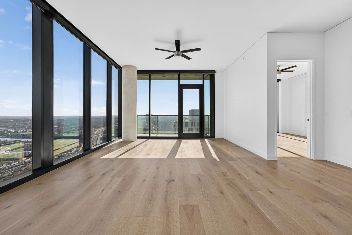 610 Davis Street, Unit 5001 Austin, TX 78701 - Photo 5 of 38 a view of an empty room with wooden floor and a window