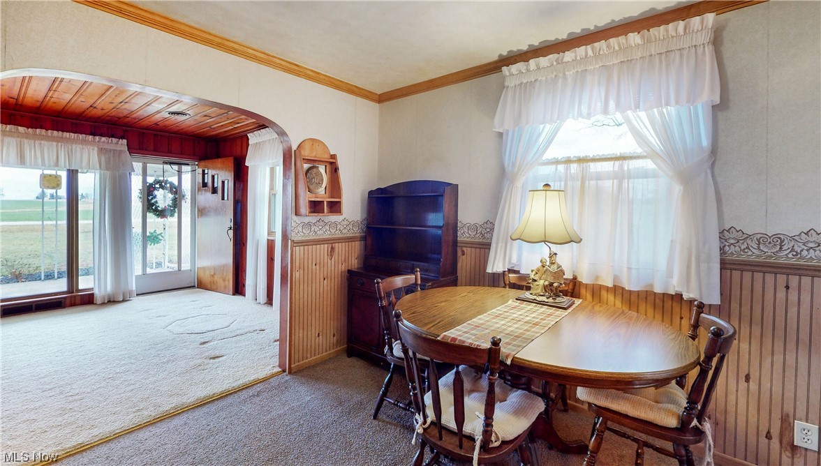 466 Pine Lake Road Sebring, OH 44672 - Photo 21 of 30 Dining room with ornamental molding and dark colored carpet