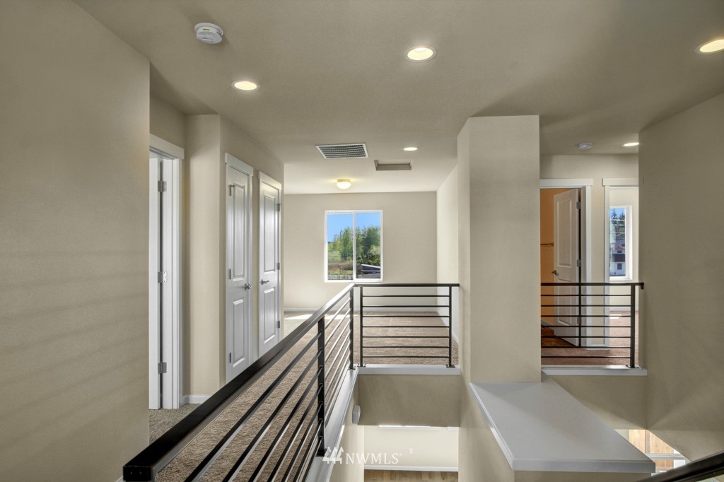 3526 178th Place Southeast, Unit 3012 Bothell, WA 98012 - Photo 13 of 20 a view of a hallway with wooden floor and staircase