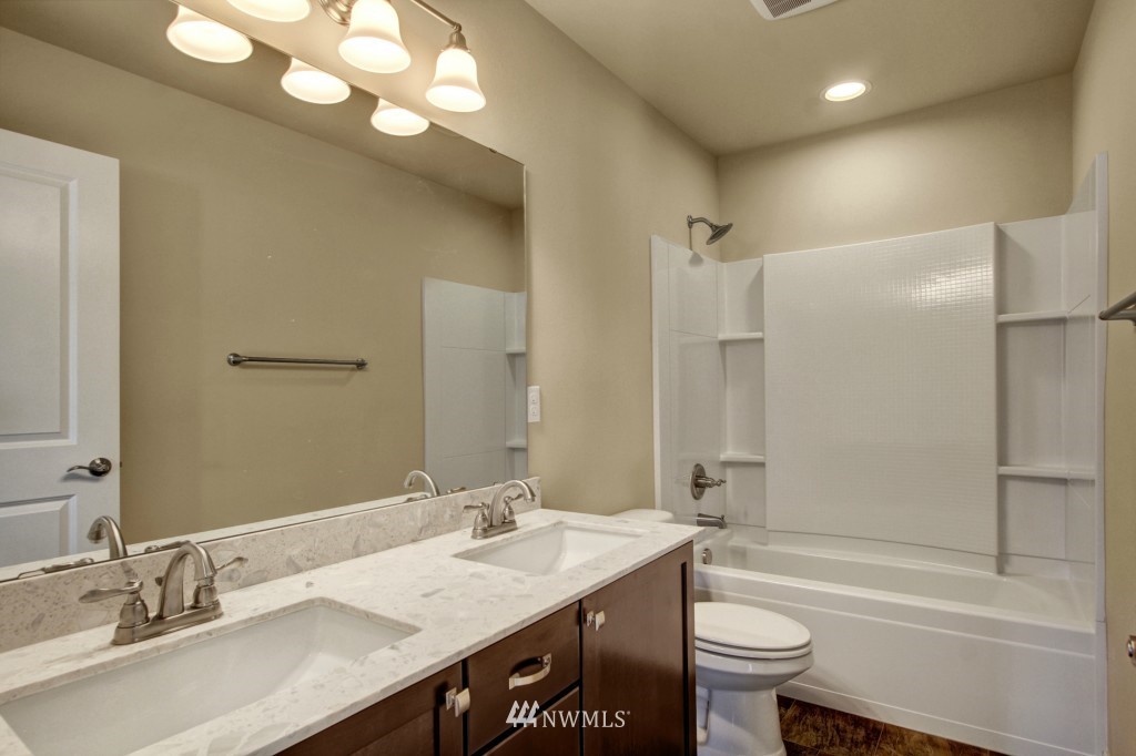 3526 178th Place Southeast, Unit 3012 Bothell, WA 98012 - Photo 14 of 20 a bathroom with a granite countertop sink toilet and shower