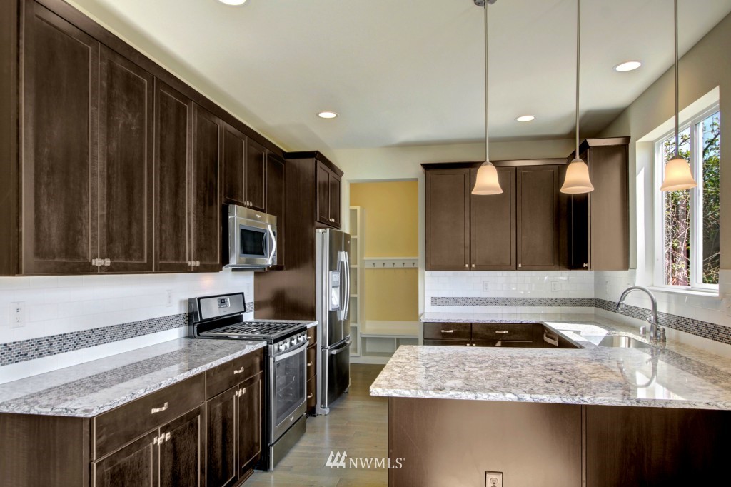 3526 178th Place Southeast, Unit 3012 Bothell, WA 98012 - Photo 4 of 20 a kitchen with a stove and a sink