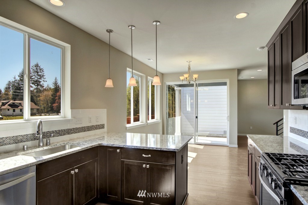 3526 178th Place Southeast, Unit 3012 Bothell, WA 98012 - Photo 5 of 20 a kitchen with a sink stove and cabinets