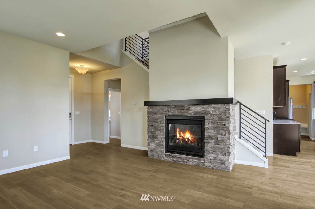 3526 178th Place Southeast, Unit 3012 Bothell, WA 98012 - Photo 9 of 20 a view of an empty room with wooden floor fireplace and a window