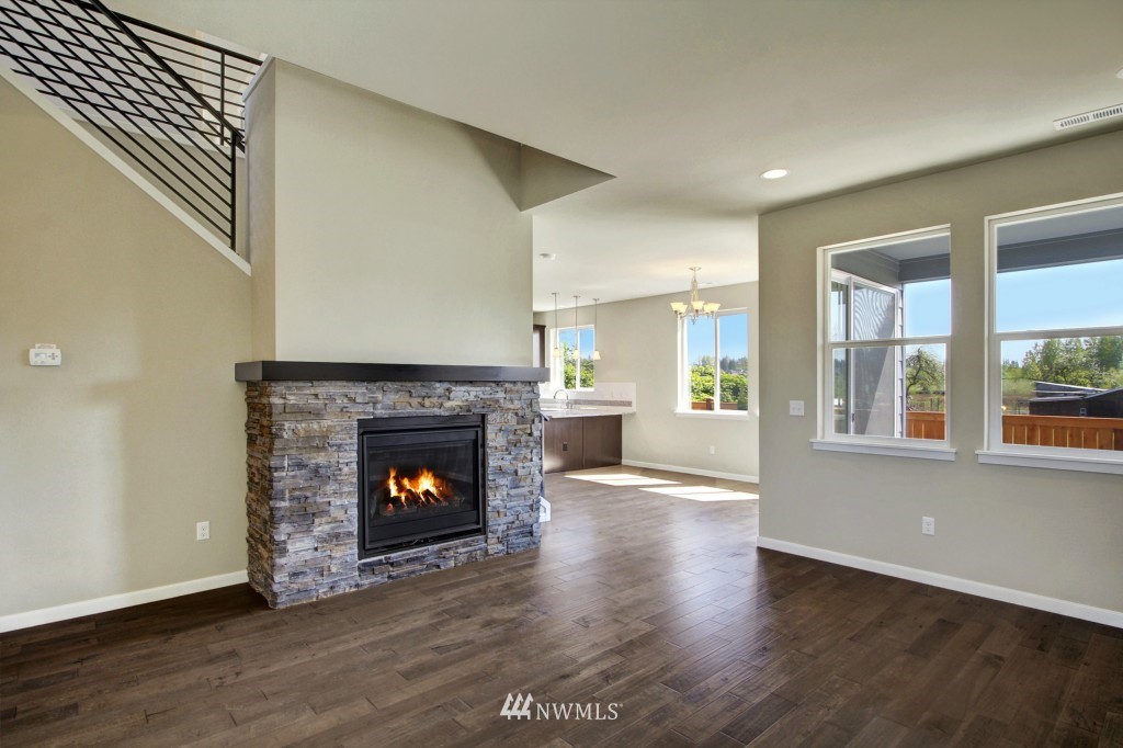3526 178th Place Southeast, Unit 3012 Bothell, WA 98012 - Photo 10 of 20 a living room with wooden floor and a fireplace