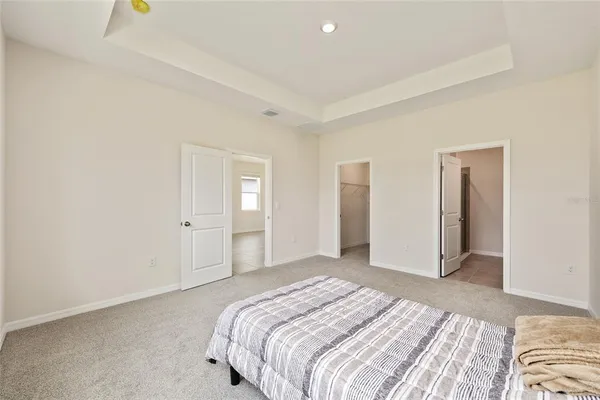a bathroom with a granite countertop sink a toilet and a mirror