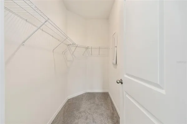 a bathroom with a granite countertop sink a toilet and a mirror