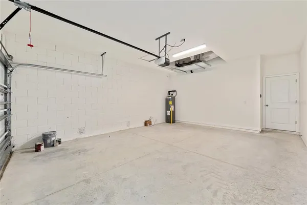 a backyard of a house with yard table and chairs