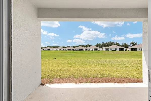 an aerial view of residential houses with outdoor space and lake view