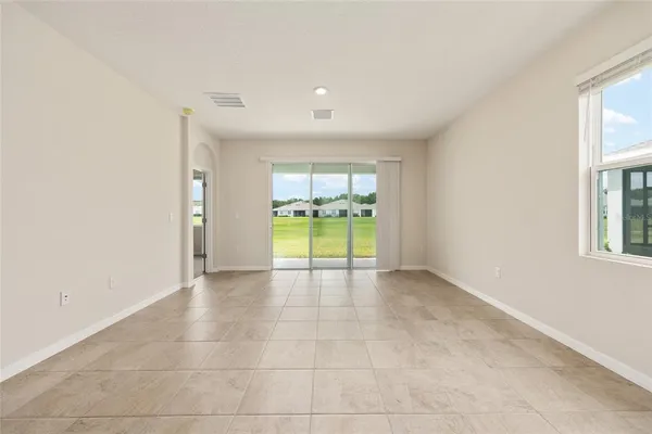 an empty room with a bathroom and a sink