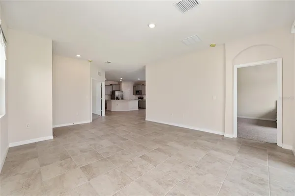 a view of kitchen with kitchen island a white cabinets and stainless steel appliances