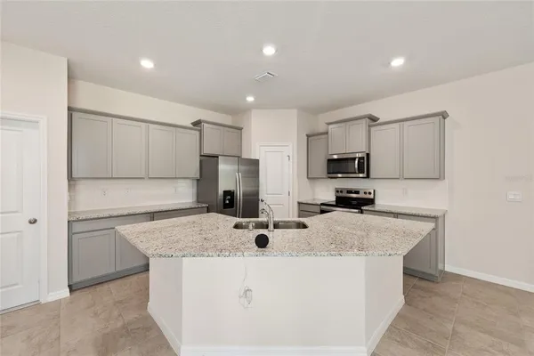 a bedroom with a bed and painting on the wall