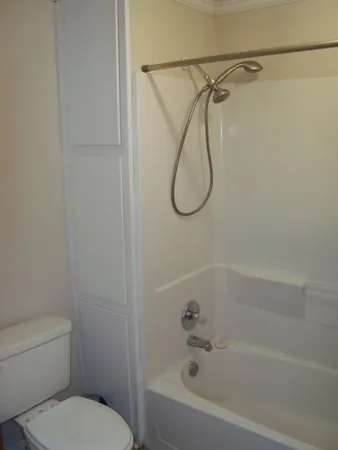 a bathroom with a shower a toilet and a shower