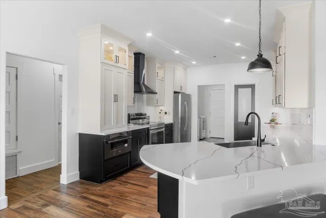 a kitchen with stainless steel appliances a refrigerator and a stove
