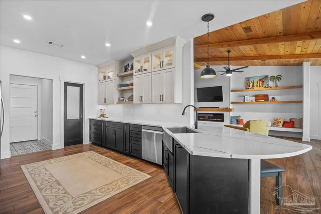 a kitchen with stainless steel appliances granite countertop a sink a stove and a refrigerator