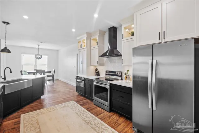 a kitchen with stainless steel appliances a stove and a refrigerator