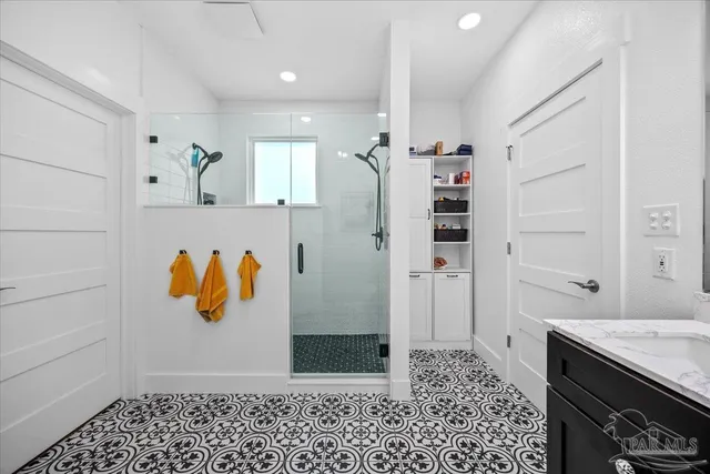 a bathroom with a sink vanity and mirror