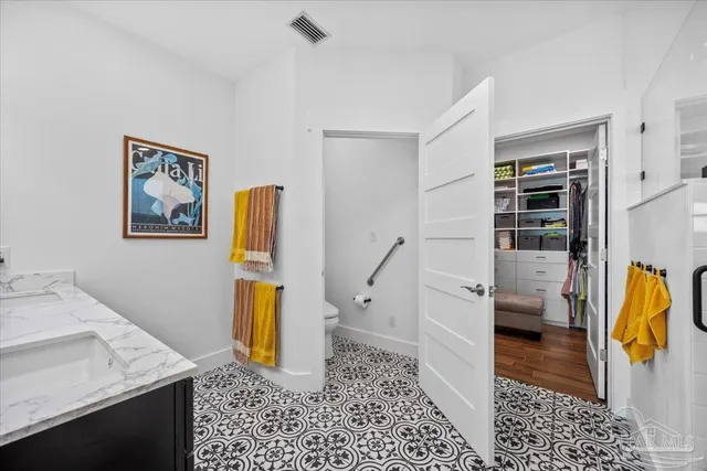 a view of walk in closet with clothes and shoes