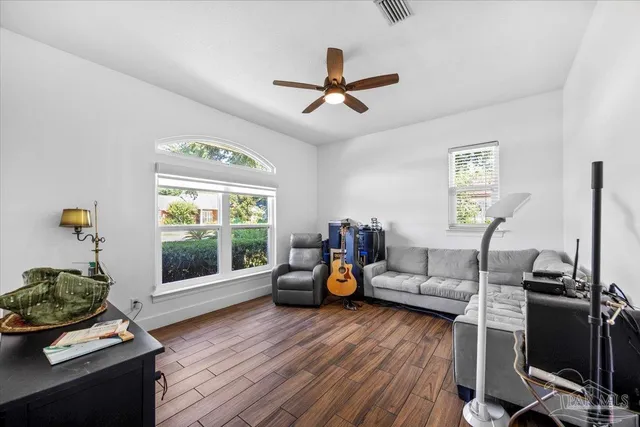 a front view of house with yard and trees in the background