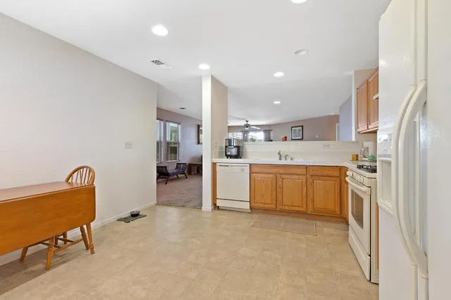 a kitchen with stainless steel appliances kitchen island granite countertop a sink and cabinets