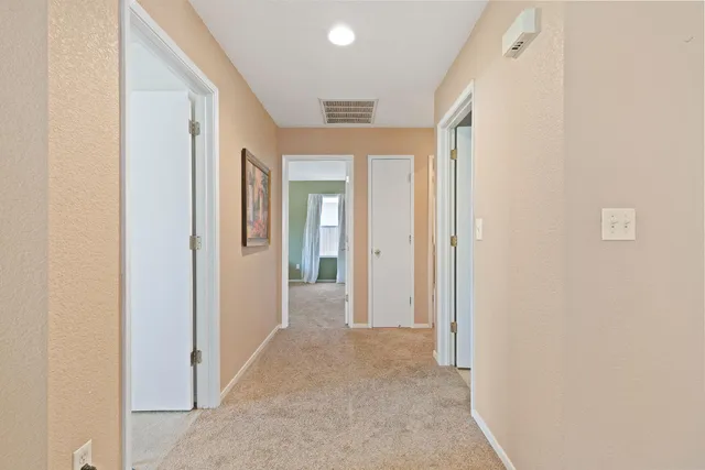 view of a hallway with wooden floor and closet