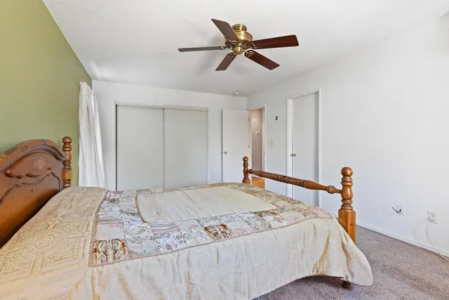 a bedroom with a bed and a dresser