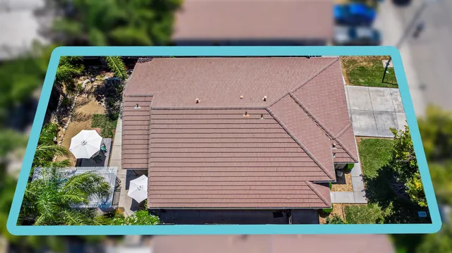 an aerial view of a house with a yard and lake view