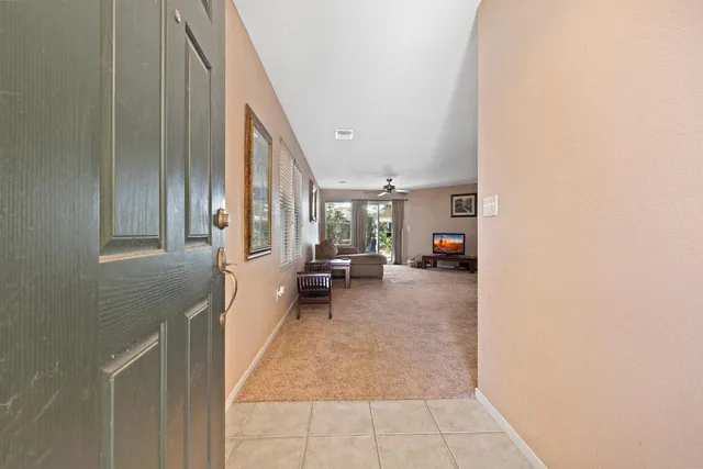 a view of a hallway with furniture and a window