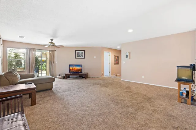 a living room with furniture a window and a flat screen tv