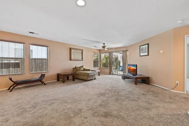 a view of a livingroom with furniture and windows in it