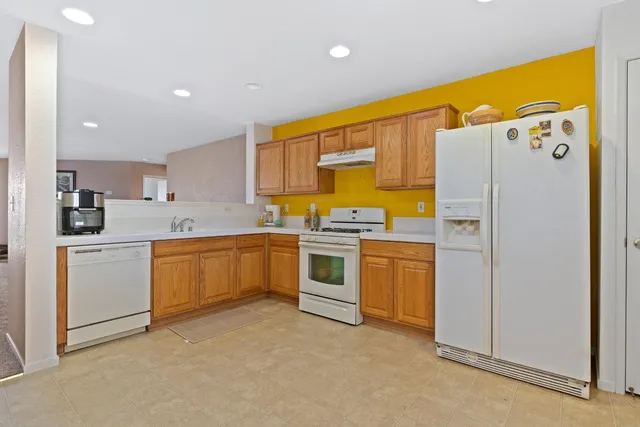 a kitchen with stainless steel appliances a refrigerator sink and cabinets