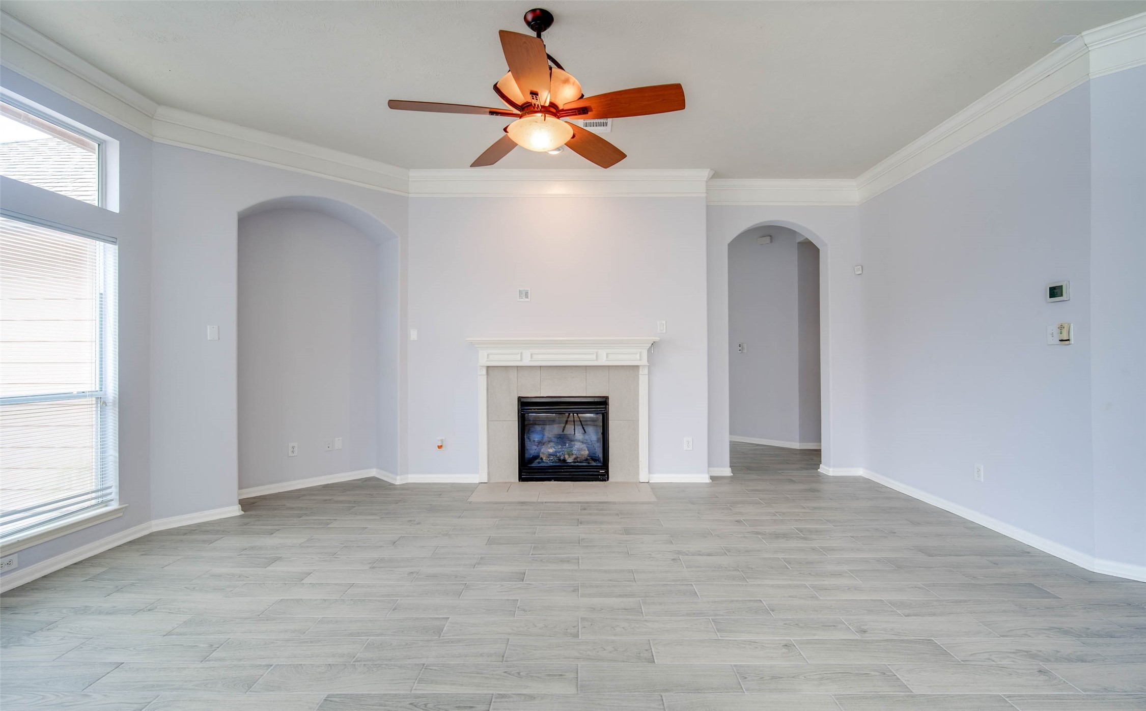 9323 Hillhaven Court Rosenberg, TX 77469 - Photo 20 of 37 wooden floor fireplace and windows in an empty room