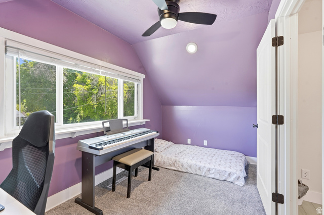 210 North 200 West Logan, UT 84321 - Photo 17 of 31 Carpeted room featuring a sloped ceiling, large window with outdoor greenery, a ceiling fan with integrated lighting, and recessed ceiling lighting