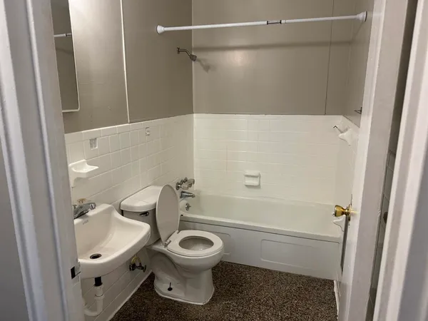 a bathroom with a toilet sink and shower