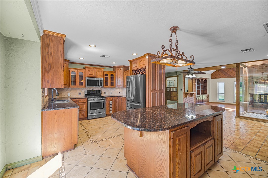 20 Hambleton Road Victoria, TX 77905 - Photo 5 of 48 a kitchen with stainless steel appliances granite countertop a sink stove and refrigerator