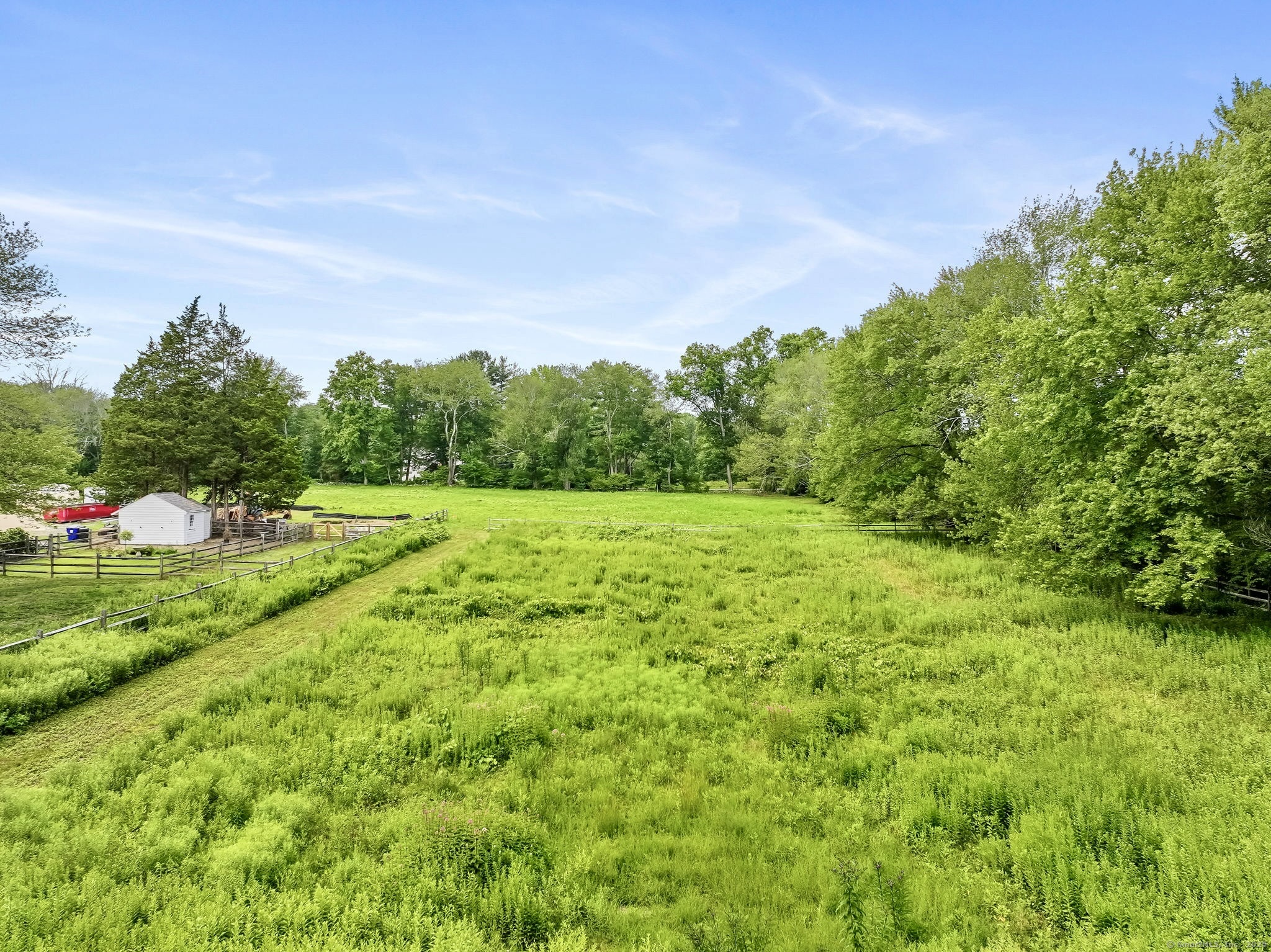 22 Brett Road Fairfield, CT 06824 - Photo 3 of 4 a view of a grassy field with trees in the background