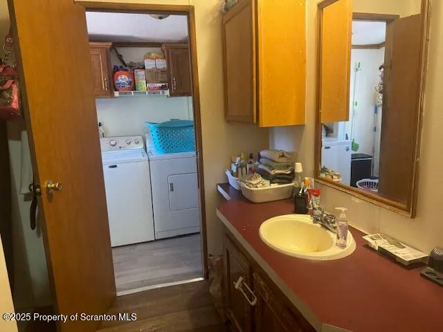 a view of a hallway with wooden floor and living room