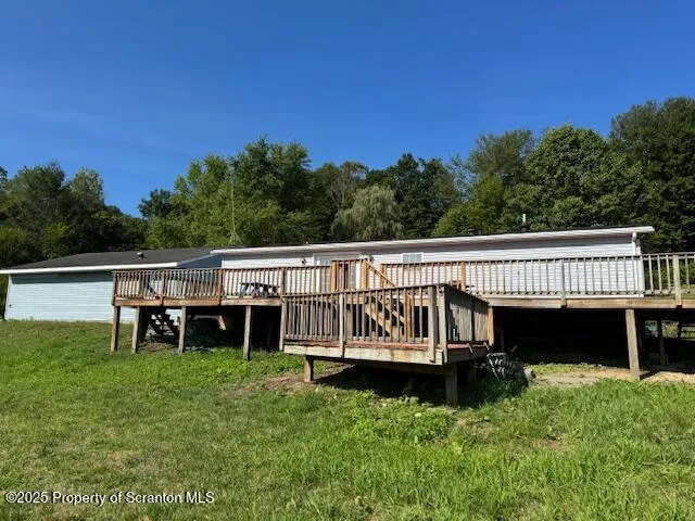 a balcony with wooden floor and outdoor space